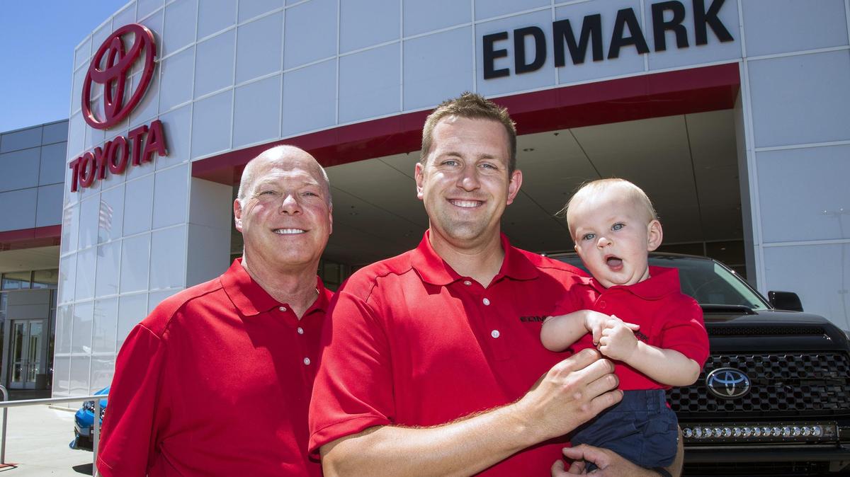 Dave Edmark, 60, his son, Miles Edmark, 31, and 9-month-old grandson, James Edmark, represent a family that has been in the car dealership business for 90 years in the Treasure Valley. On Tuesday, the Edmark family, which has operated Tom Scott Honda in Nampa since April 2017, will change the name of the dealership to Edmark Toyota.