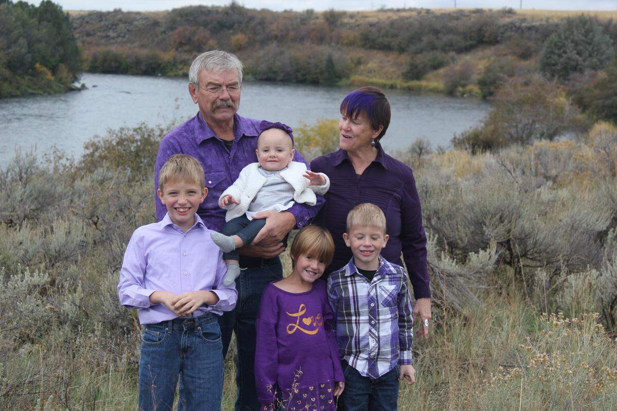John Nedrow and his wife, Sheila, and their four grandchildren stand on their property overlooking the Henry’s Fork of the Snake River.