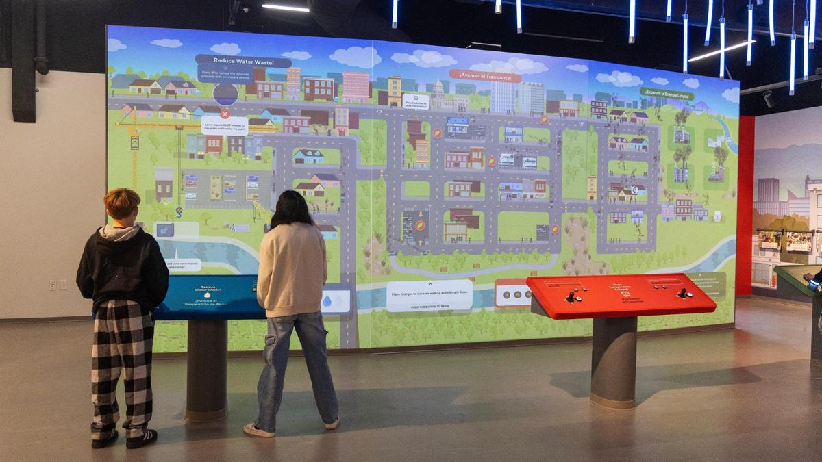 Students play a climate-themed game on a large interactive screen during a field trip to the WaterShed Climate + Water Education Center on March 13.