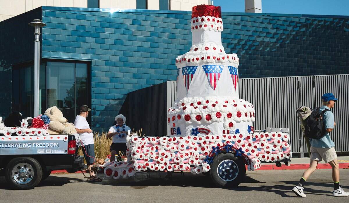 Float operators stage their entries in the Brady Garage parking lot at Boise State, near Capitol Boulevard, ahead of Boise's Fourth of July parade Saturday. Floats included a large cake honoring the country's 250th birthday.