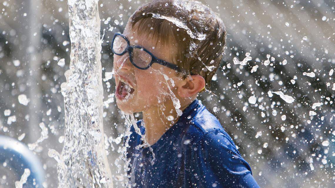 Elijah Holfeltz, 8, cools off with a splash at the children’s water playground at Borah Pool in Boise Friday, Aug. 10, 2018. Temperatures had climbed to 105 degrees by 3 p.m. Elijah was with his younger brother Chayton and Jamie Holfeltz, his mother.