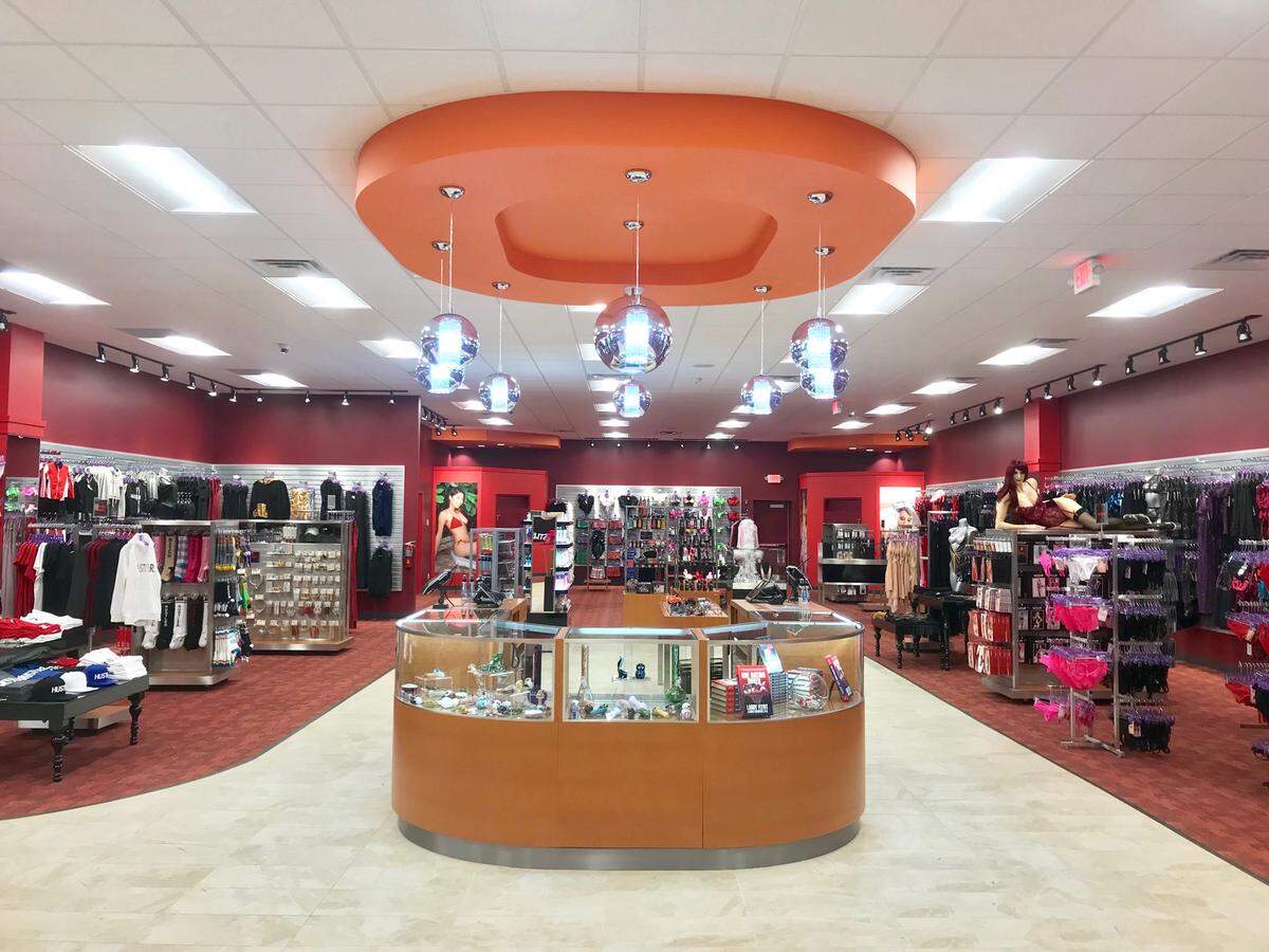 The interior of a typical Hustler Hollywood boutique features lots of apparel and items with the Hustler logo.