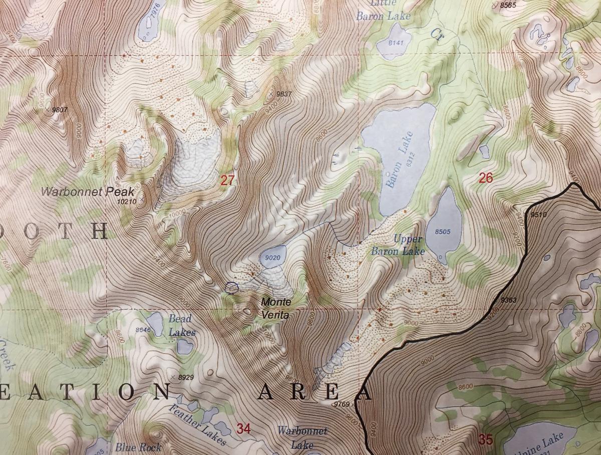 Dick Ross was injured when two boulders struck him along a pass on the shoulder of Monte Verita, above Baron Lake. The circle left of Monte Verita marks the spot where he was injured and later rescued by helicopter.