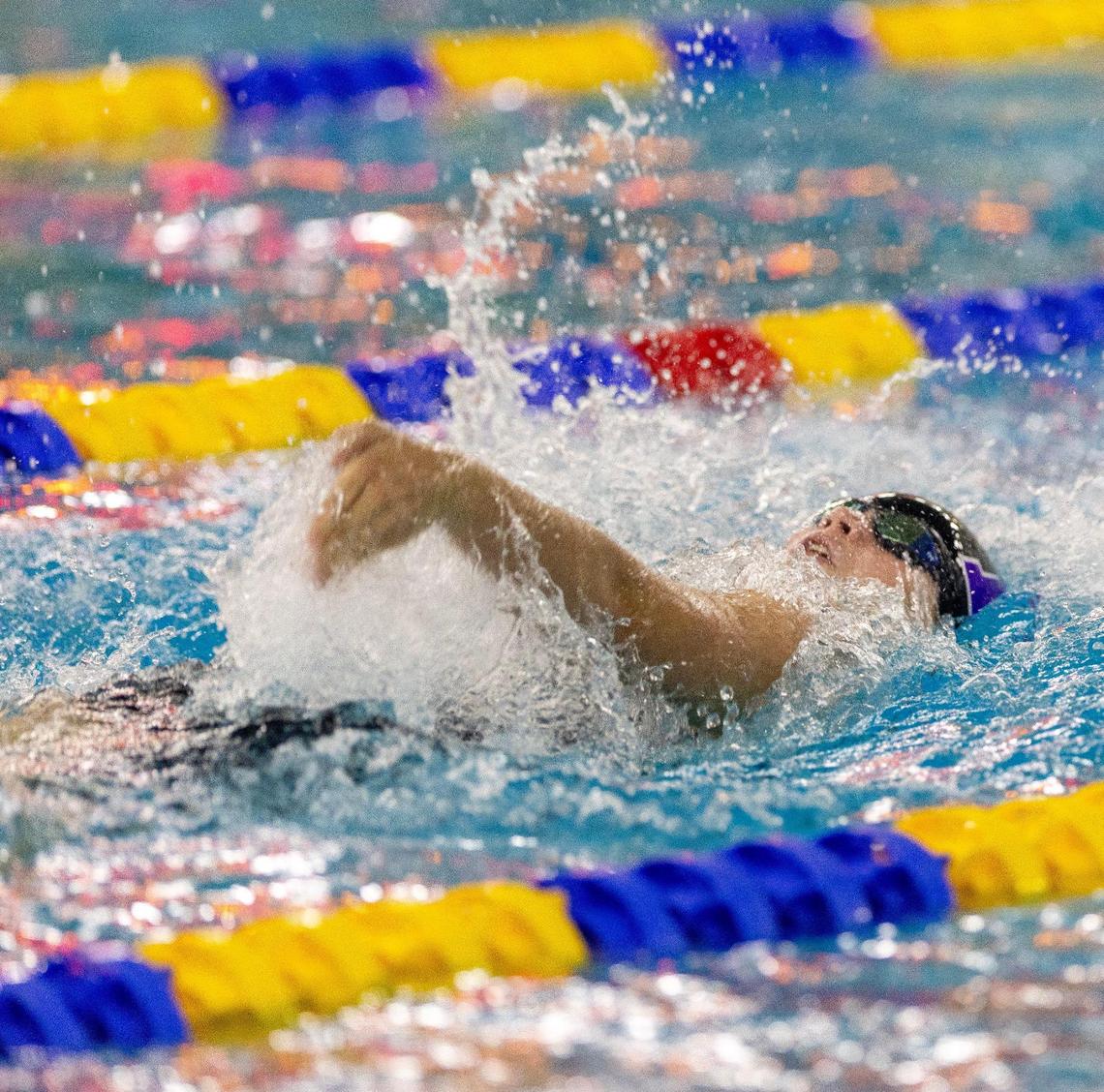 Rocky Mountain’s Keegan Near competes in the 100-yard backstroke during the 5A state meet held at the West Family YMCA and Boise City Aquatic Center last season.