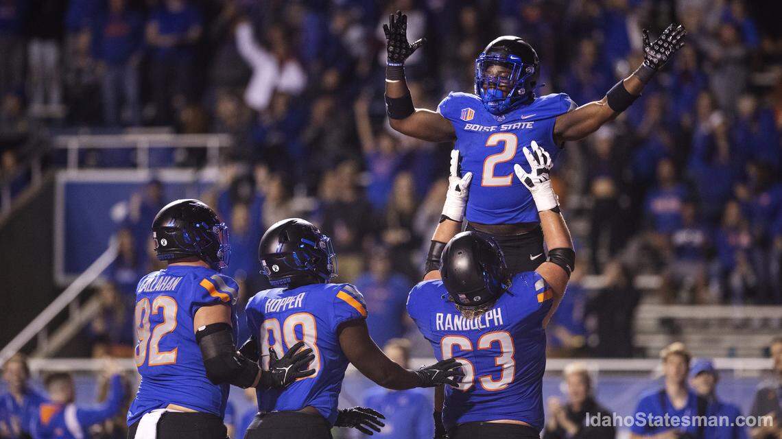 Boise State running back Ashton Jeanty is lifted up by teammate Boise State offensive lineman Mason Randolph after Jeanty’s touchdown in the fourth quarter of their game against Fresno State at Albertsons Stadium on Saturday, Oct. 8, 2022. The Broncos 40-20.