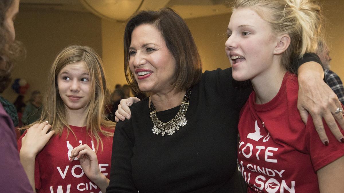 Flanked by great-nieces Kamree Dean, 12, left, and Lexie Dean, 14, Cindy Wilson, Democratic candidate for superintendent, greets supporters at the Democratic election night party at the Grove Hotel on Tuesday, Nov. 7, 2018.