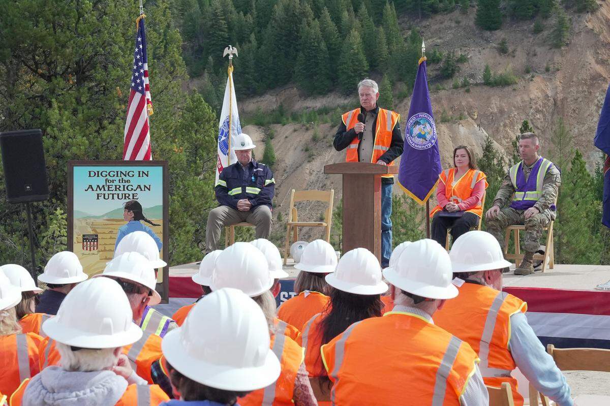 Idaho Gov. Brad Little addresses attendees for a ribbon-cutting event at the site of a proposed gold and antimony mine in the Payette National Forest. On stage, he was joined by (from left to right) Jon Cherry, president and CEO of Perpetua Resources, U.S. Department of Agriculture Deputy Undersecretary Kristin Sleeper and U.S. Army Maj. Gen. John Reim.
