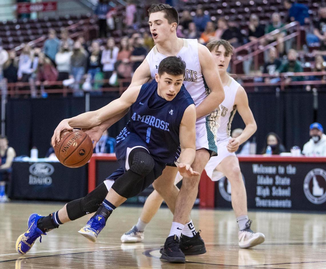 Ambrose senior Johnny Sugarman drives on St. Maries’ Coleman Ross in the 2A boys state basketball championship March 6 at the Ford Idaho Center in Nampa.