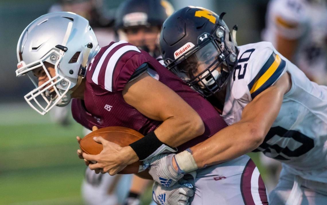 Meridian linebacker Nathan Reynolds drops Centennial wide receiver Peyton Allen during last year’s season opener.