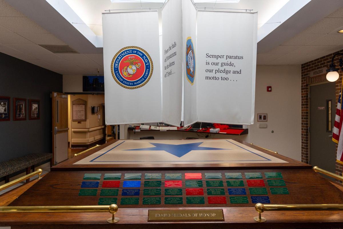 Banners with the emblems and mottos of the branches of the Armed Forces hang inside the front lobby of the home.