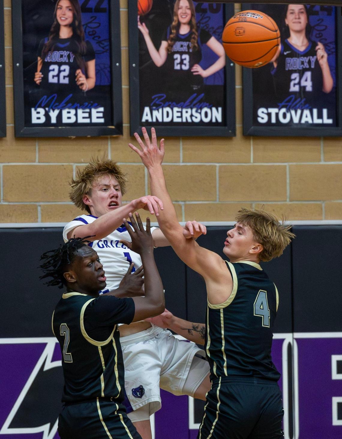 Rocky Mountain guard Tanner Sweaney kicks a pass back out to the perimeter while defended by Capital’s Yassin Muktar and Jack Smith during a game last week in Meridian.