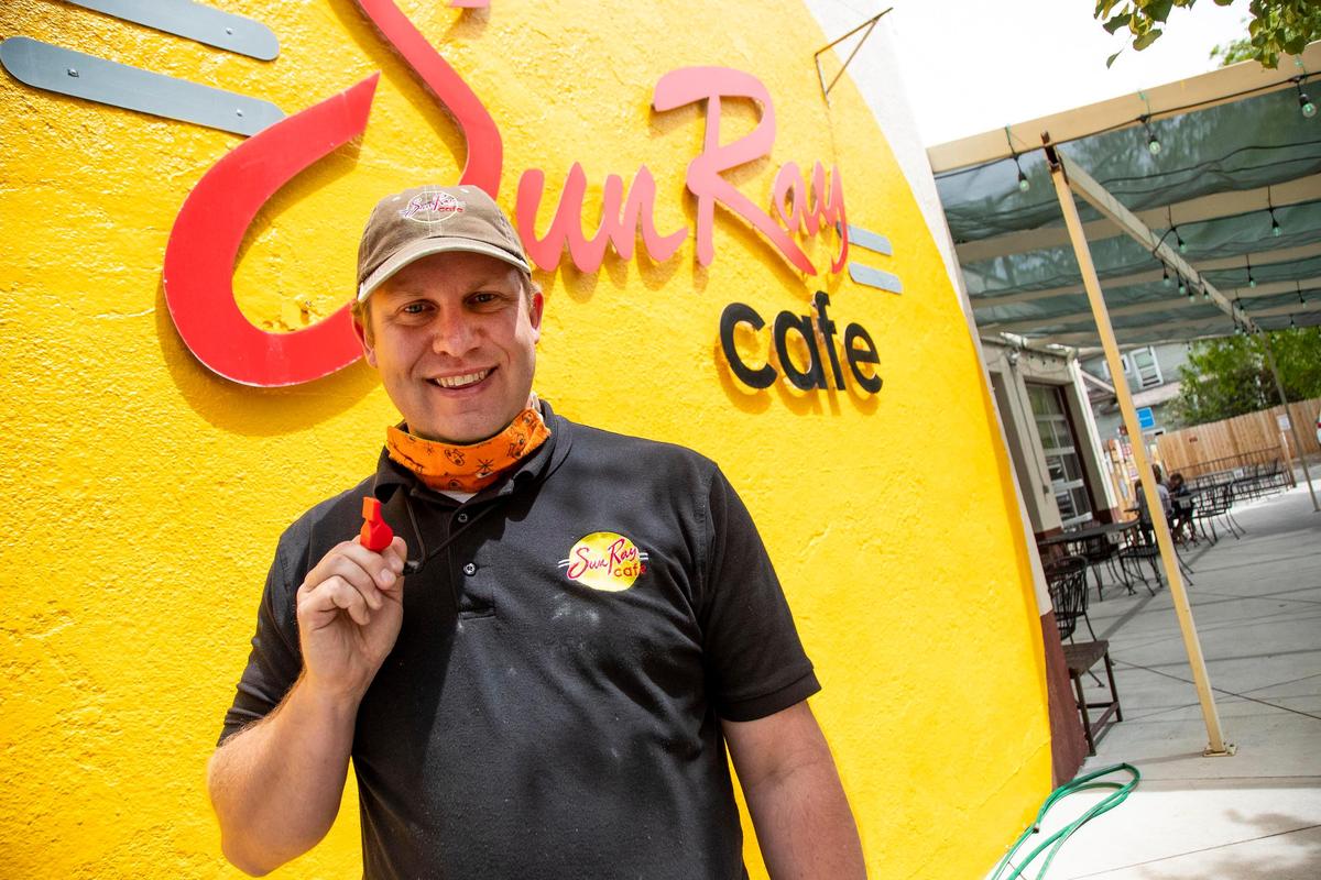 Todd Martin, general manager at Sun Ray Cafe in Hyde Park, holds his old lifeguard whistle at the ready on the first day of Gov. Brad Little’s Stage 2 of reopening Idaho businesses on Saturday, May 16, 2020. “We don’t want to get overwhelmed,” he said, referring to maintaining COVID-19 social distancing guidelines as people are now being allowed to dine in. “I’m really excited that our guests can come back and take advantage of what we have to offer them.”