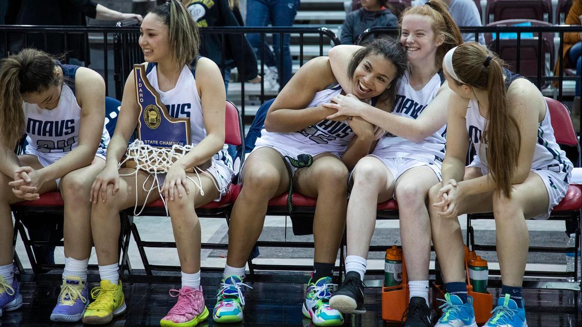Mountain View’s Naya Ojukwu, center, gets a hug from teammate Emily Morandi as the girls basketball team celebrates a 55-49 victory over Timberline in the 5A state championship Saturday, Feb. 22, 2020 at Ford Idaho Center in Nampa.