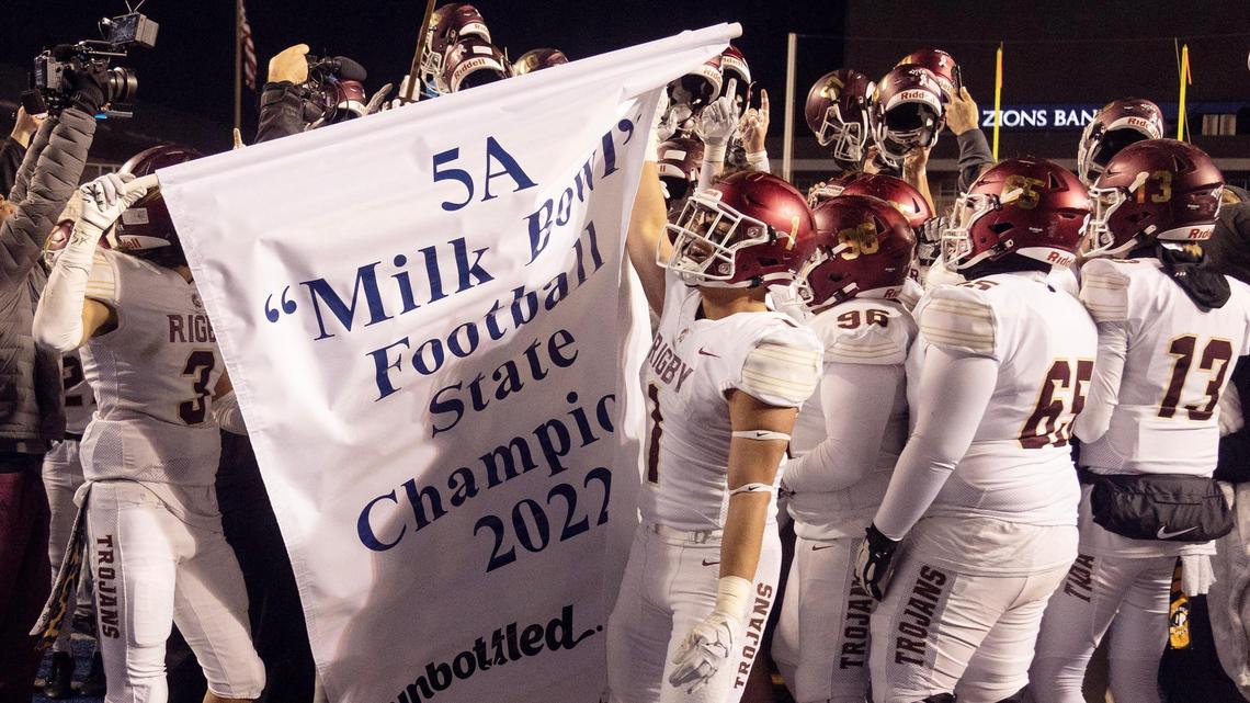 Rigby celebrates with the 5A state championship banner after rallying for a 28-21 victory over Meridian on Friday at Boise State’s Albertsons Stadium.