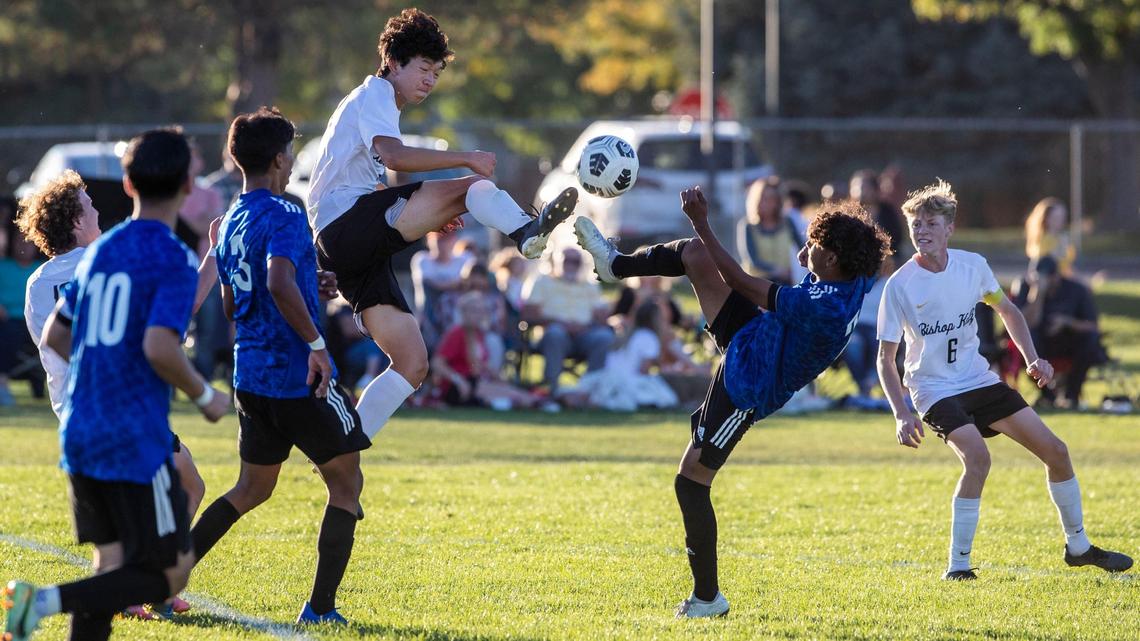 Bishop Kelly midfielder Andrew Nguyen, left, and Caldwell’s Axel Gonzalez battle for a bouncing ball Thursday in the 4A District Three boys soccer championship at Vallivue. Caldwell won 2-0 to repeat as district champ.