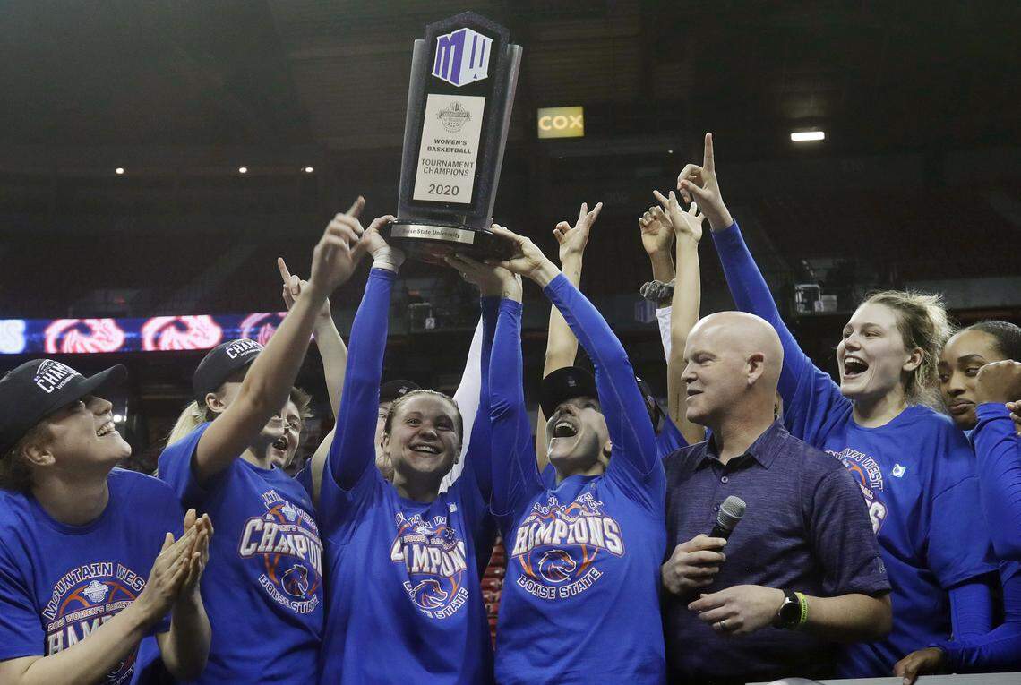Boise State players hoist the trophy after defeating Fresno State 80-76 in overtime for the Mountain West Tournament title Wednesday at the Thomas & Mack Center in Las Vegas.