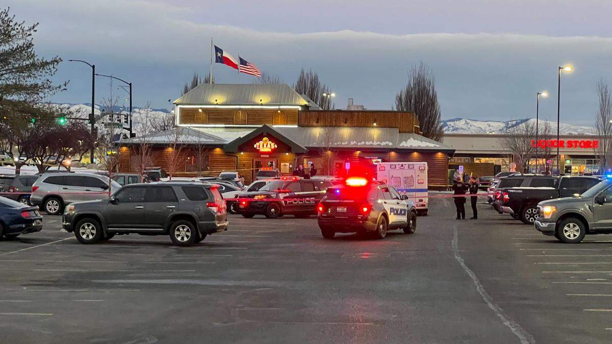 Police vehicles and an ambulance, as well as police tape, mark the scene of a police shooting Monday evening behind the Texas Roadhouse along Fairview Avenue, just west of the Boise-Meridian city line.
