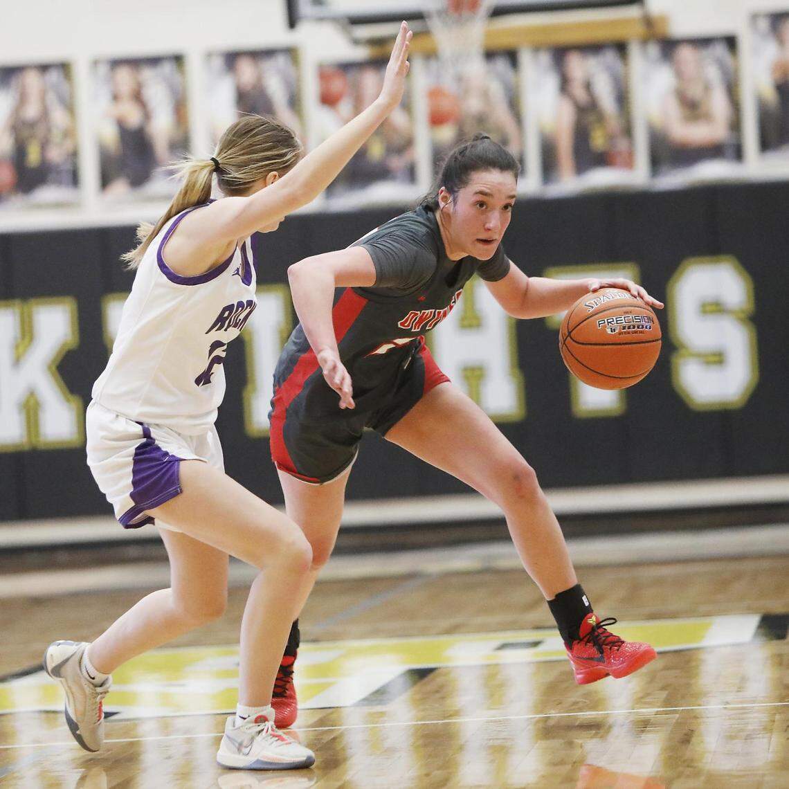 Owyhee’s Sydnie Rodriguez tries to bring the ball up the court under pressure from Rocky Mountain’s Averee Osterhout in the 5A girls basketball state tournament consolation final Saturday at Bishop Kelly High.