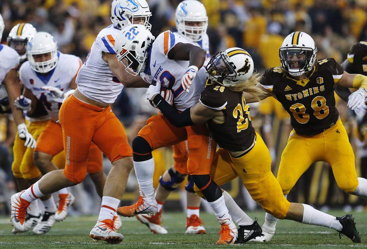 Boise State running back Alexander Mattison is brought down by Wyoming free safety Andrew Wingard.