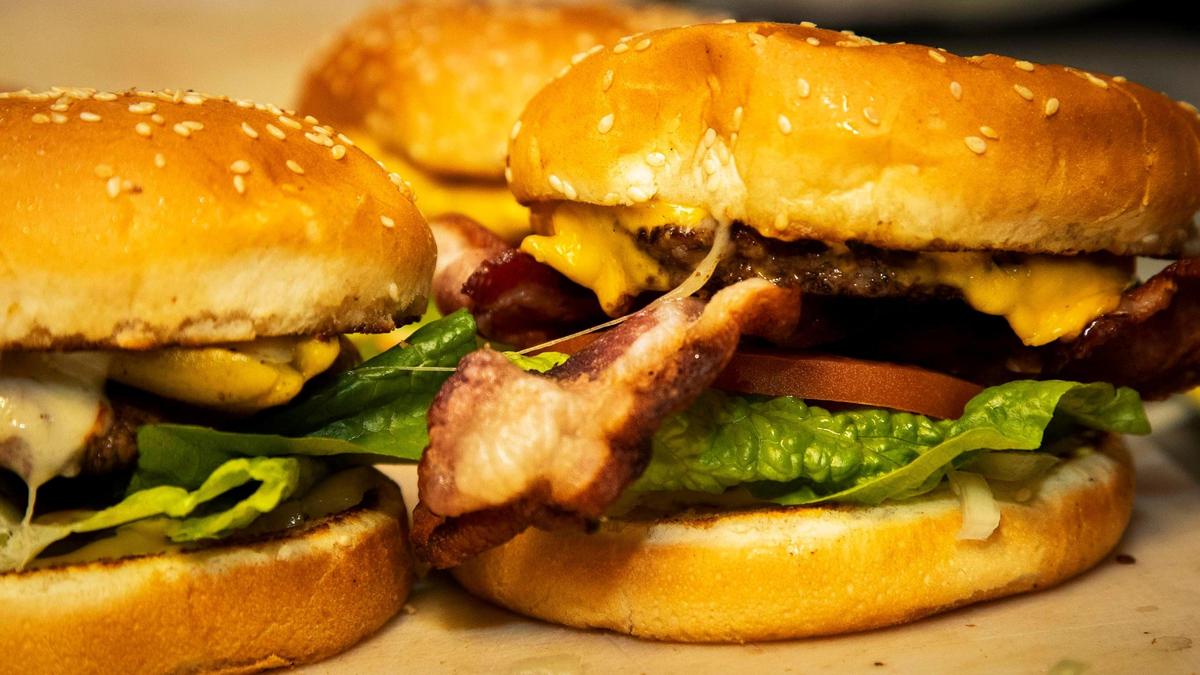Bacon cheeseburgers fresh off the grill await plating for hungry patrons at The Dutch Goose on State Street on Tuesday.