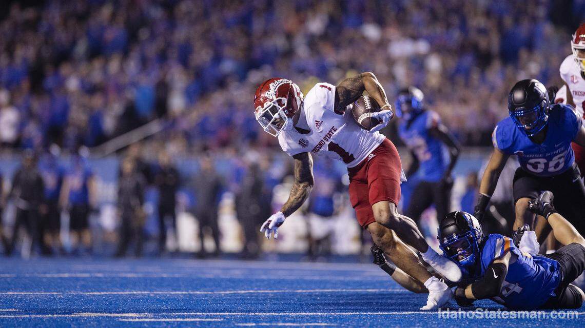 Fresno State wide receiver Nikko Remigio is tripped up by Boise State safety Alexander Teubner in the fourth quarter of their game against Fresno State at Albertsons Stadium on Saturday, Oct. 8, 2022. The Broncos 40-20.