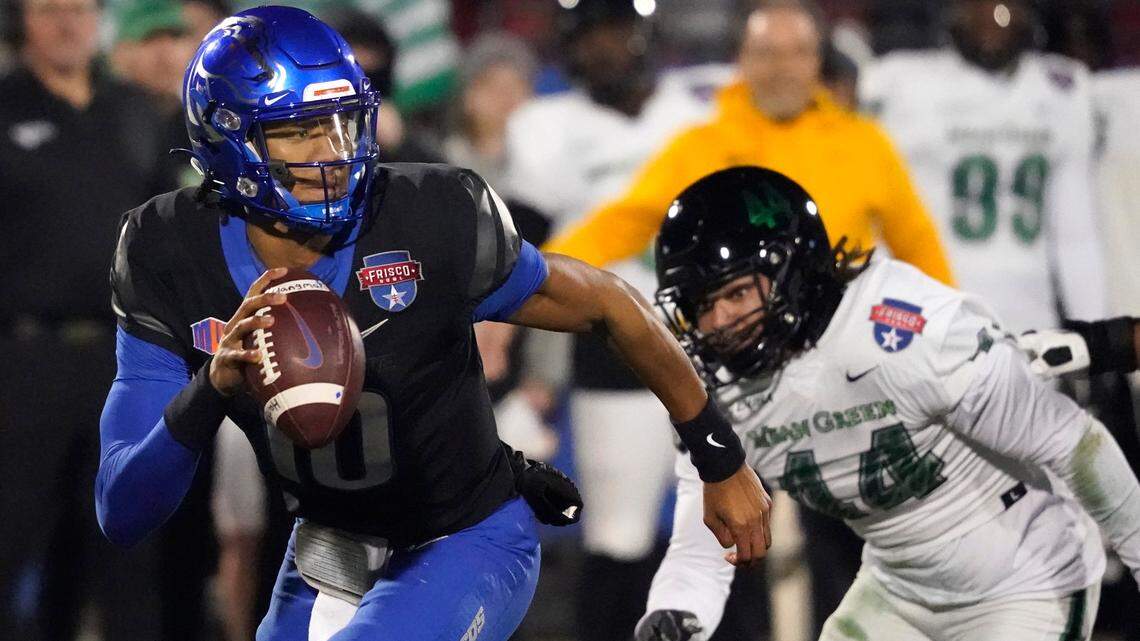 Boise State quarterback Taylen Green (10) evades pressure in the first half of the Broncos’ 35-32 win over North Texas in the Frisco Bowl on Saturday. Green threw for 137 yards and a touchdown and added 119 yards and two touchdowns on the ground.
