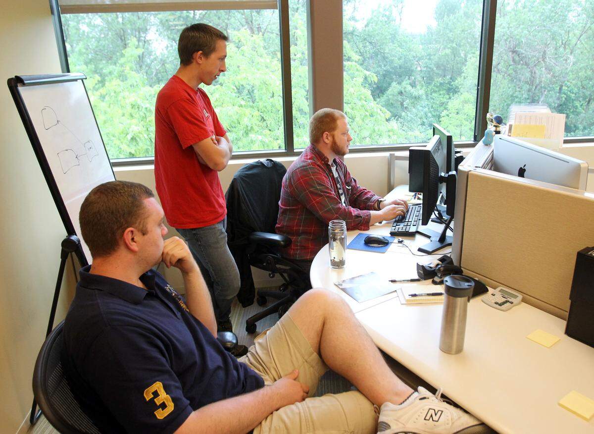 Software development interns Will Dietrich, left, and Jared Ostyn, center, meet with Issac Howard, Kount’s senior quality assurance manager, in May 2013. Ten years earlier, hardware was king in Idaho’s tech sector. By 2013, with companies like HP and Micron with a smaller footprint in the valley, software was surging. Since its launch in 2008, Kount had expanded from 15 customers to about 300. 