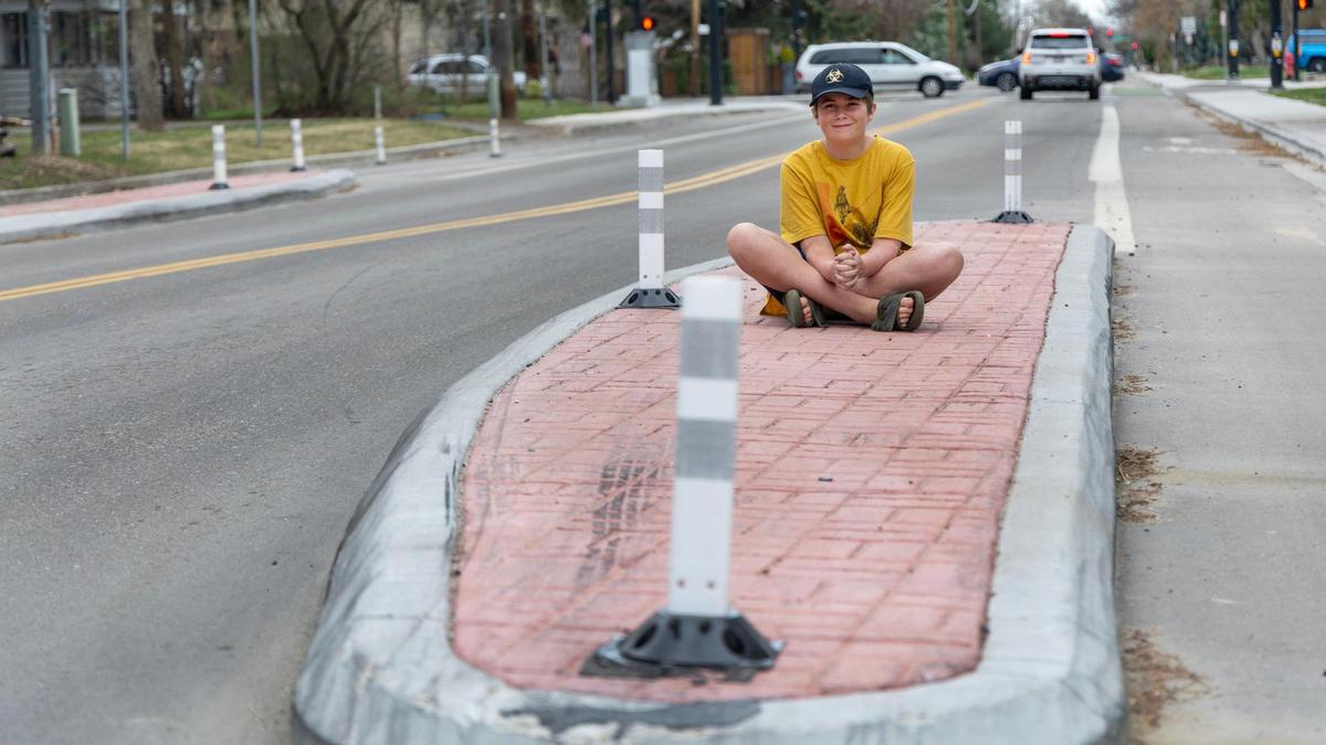 Max Wyatt sits on a chicane on Kootenai Street in Boise that ACHD built eight years after his crash.