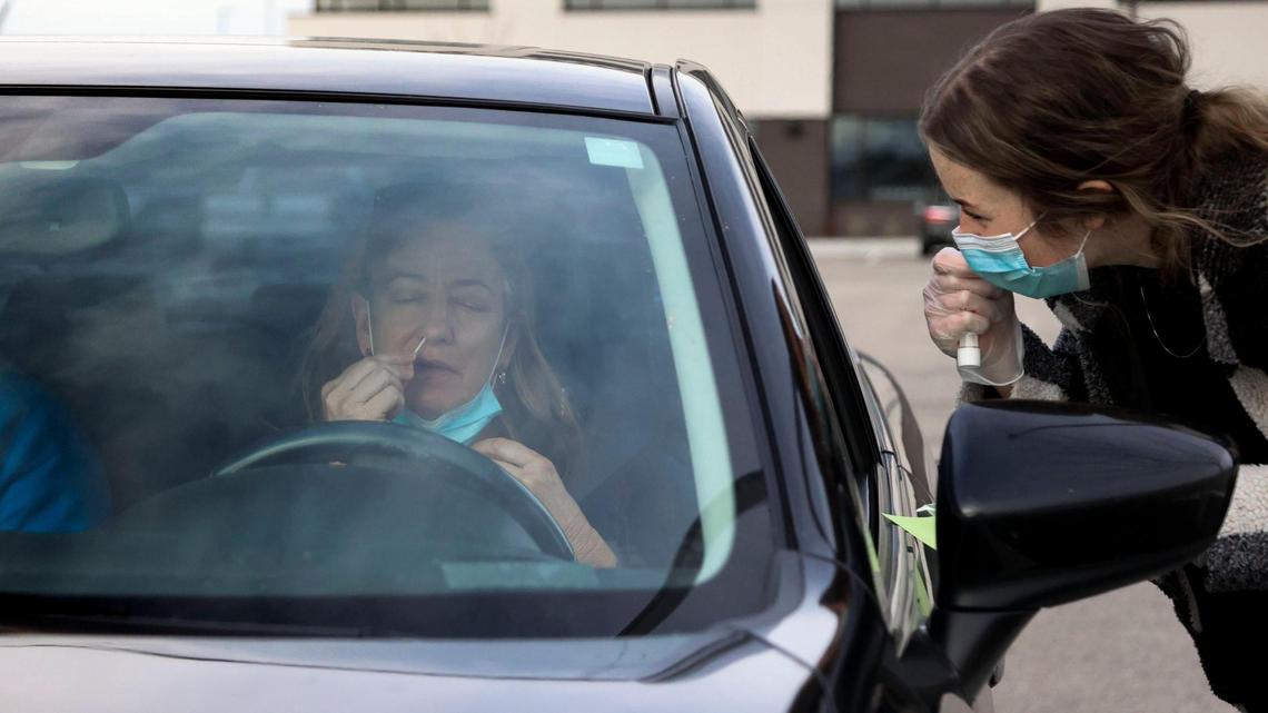 Gage Young takes a COVID-19 swab test with guidance from Crush The Curve team member Brinley Oswald at a drive-up testing site in Meridian on Tuesday.