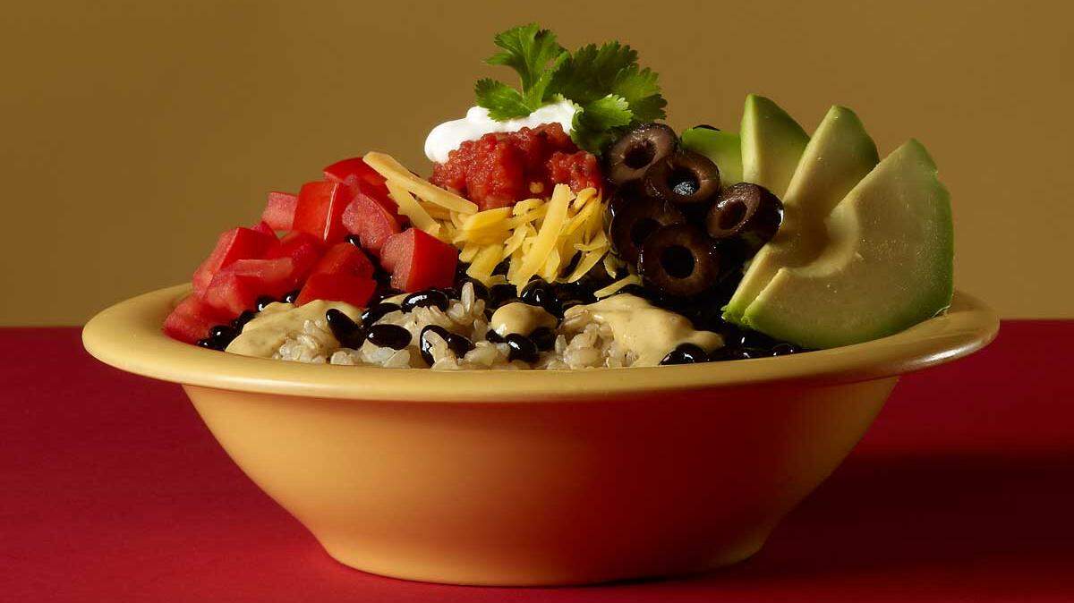 Rice and beans provide the layered groundwork for healthy Yumm! bowls, which are taken to the next level by Original Yumm! Sauce.