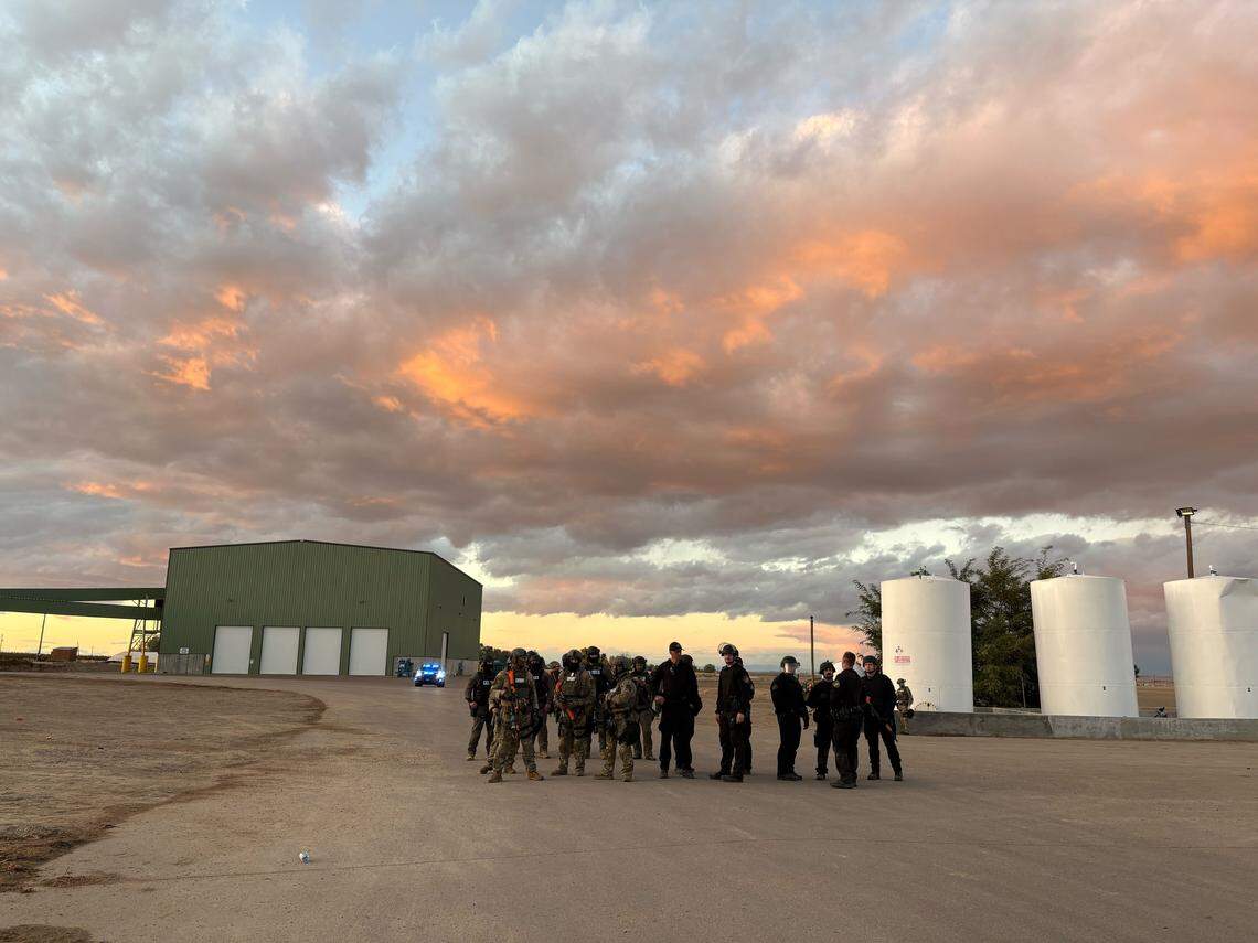 Agents stand at La Catedral Arena in Wilder, Idaho, after a raid Sunday as part of an investigation into alleged illegal horse betting.