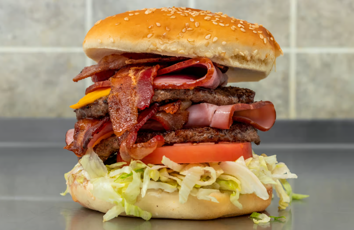 Big Bun’s monstrous 1/2-pound Tom Burger ($11.49) includes two 1/4-pound patties, two slices of American cheese, two slices of ham, two layers of Applewood-smoked bacon, mayonnaise, lettuce and tomato on a five-inch sesame seed bun.