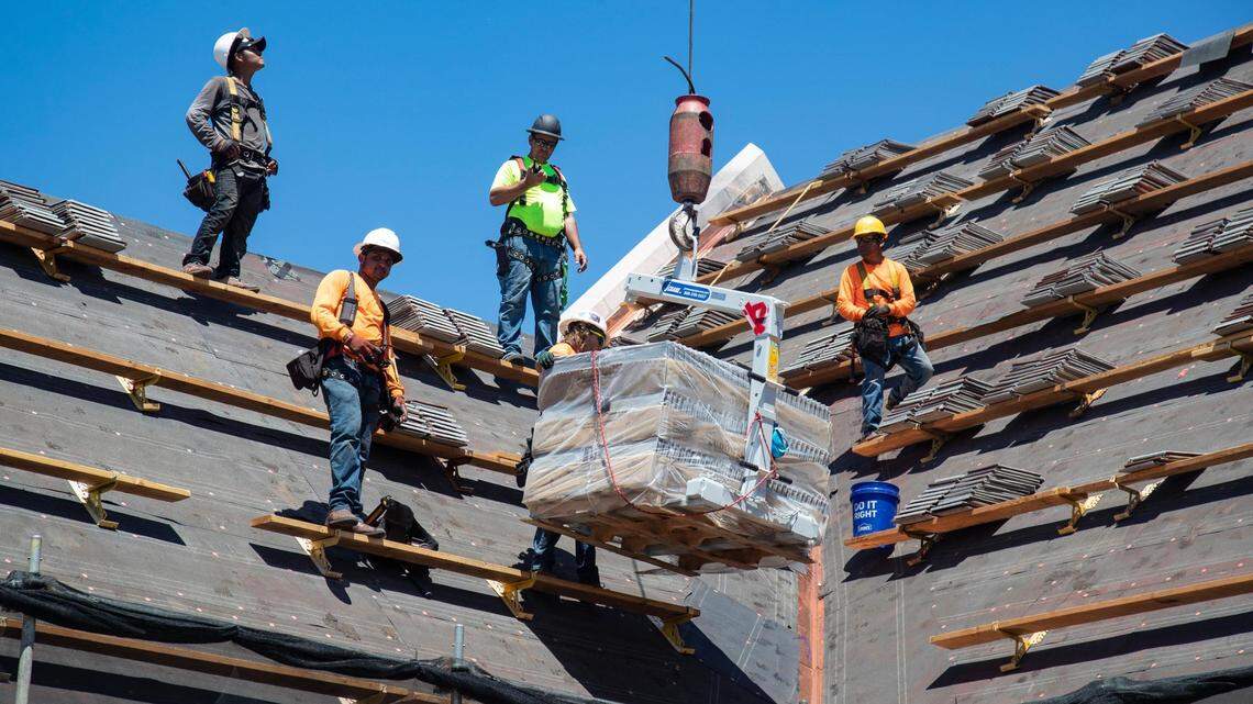 Roofers work on top of First Presbyterian Church in downtown Boise in the afternoon as temperatures exceeded 100 degrees on Tuesday, June 29, 2021.