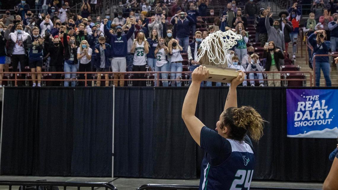 Mountain View senior Trinity Slocum presents the 5A state title to the Mavericks’ student section Saturday at the Ford Idaho Center in Nampa.