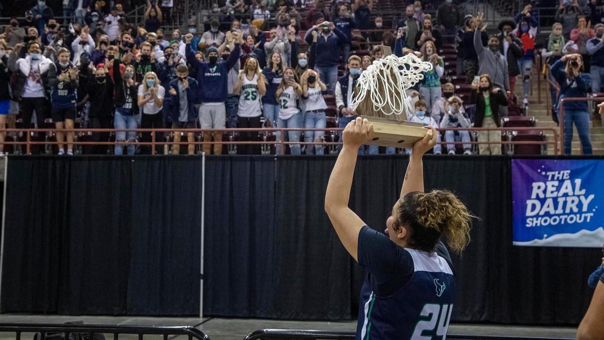 Mountain View senior Trinity Slocum presents the 5A state title to the Mavericks’ student section Saturday at the Ford Idaho Center in Nampa.
