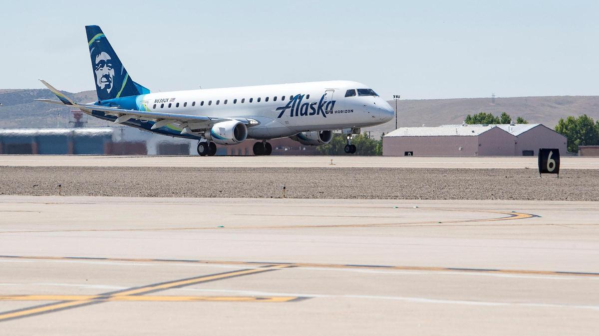 An Alaska Airlines flight had to be evacuated in Seattle after a passenger’s cellphone overheated and began to spark, airline officials said.