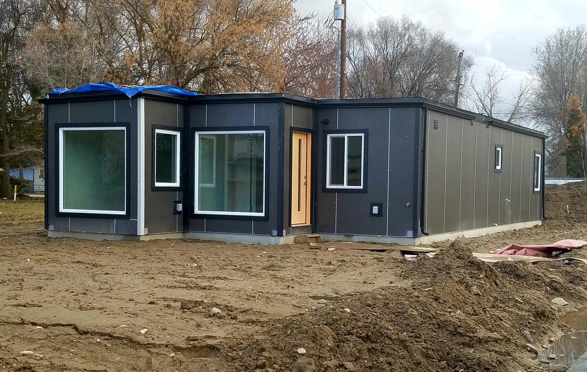 Each of the four shipping container homes in Windy Court have a different front door color to distinguish them from one another. They come with four bedrooms and two bathrooms and are energy efficient.