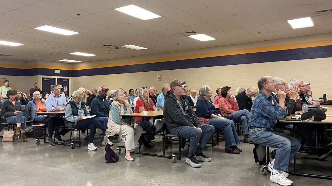 Audience members sit in the Eagle Middle School cafeteria, interrupting the forum occasionally to ask candidates to speak up.