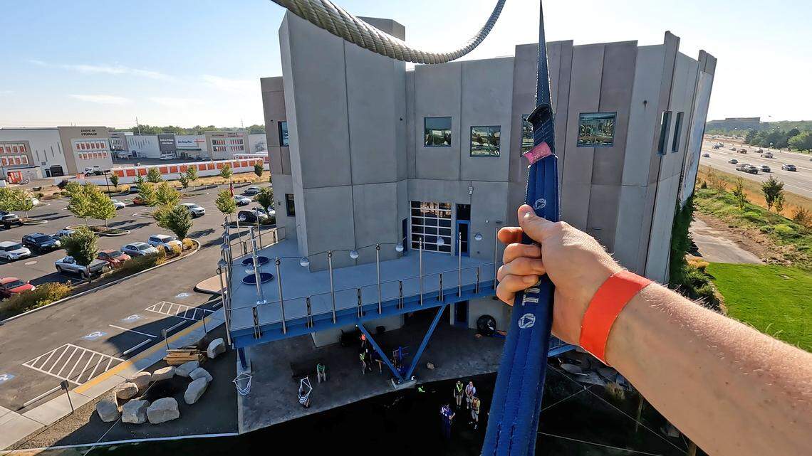 Idaho Statesman reporter Rose Evans prepares to take the free fall jump from the fourth level of the new ropes course at Vertical View, a rock climbing gym in Meridian.