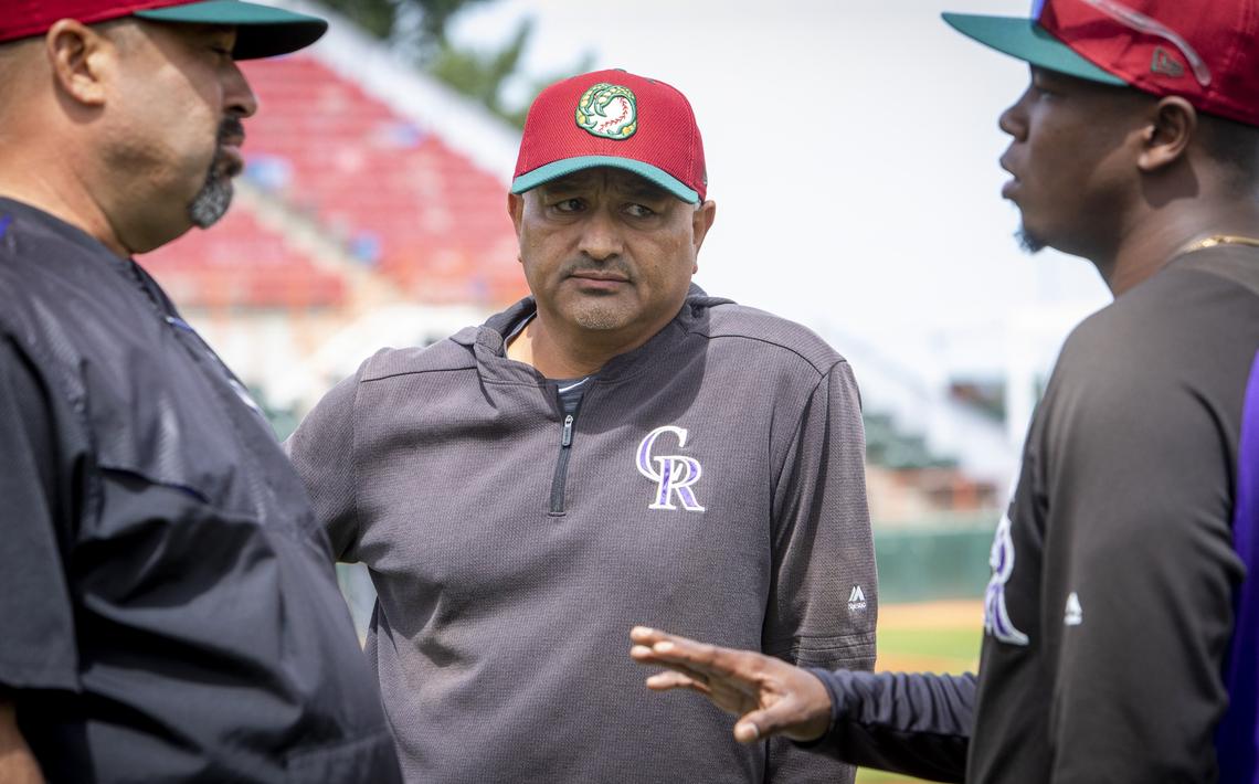 Boise Hawks manager Steve Soliz, center, talks with Rockies development supervisor Fred Ocasio, left, and Hawks hitting coach Cesar Galvez.