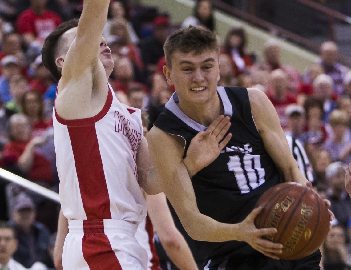 Eagle senior Connor Cooper drives on Madison’s Cooper Poll in the opening round of the 5A state boys basketball tournament Thursday, Feb. 28, 2019 at Ford Idaho Center in Nampa.
