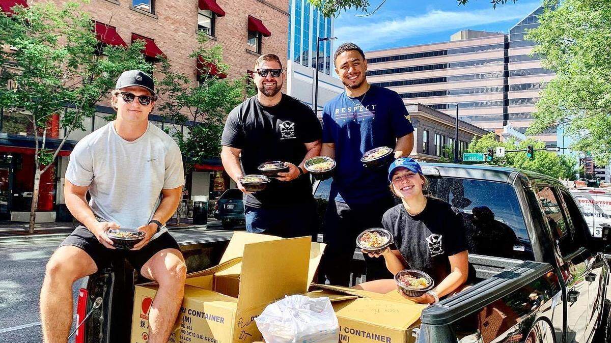 Dan Landucci, second from left, stands with staff as they hand out 500 poké bowls to St. Luke’s staff members during the COVID-19 pandemic.