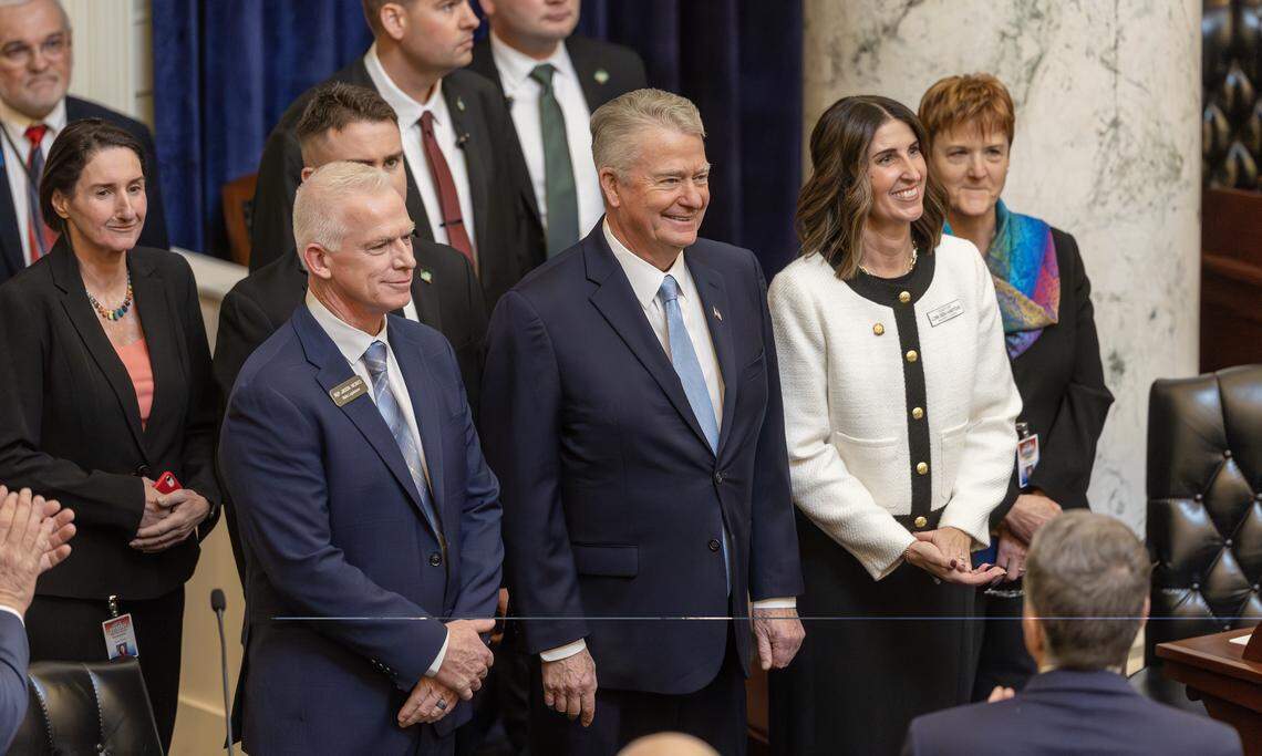 Gov. Brad Little, center, is flanked by House Majority Leader Rep. Jason Monks of Meridian, left, and Senate Majority Leader Lori Den Hartog, also of Meridian, as Little is escorted into the chambers for Monday’s State of the State address at the Capitol.