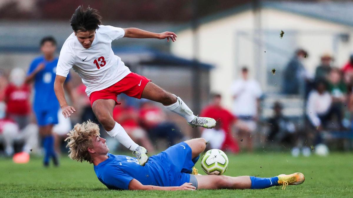 Timberline defender Jake Anderson slides under Boise’s Marcos Chavez-Miranda on a clean tackle Monday.