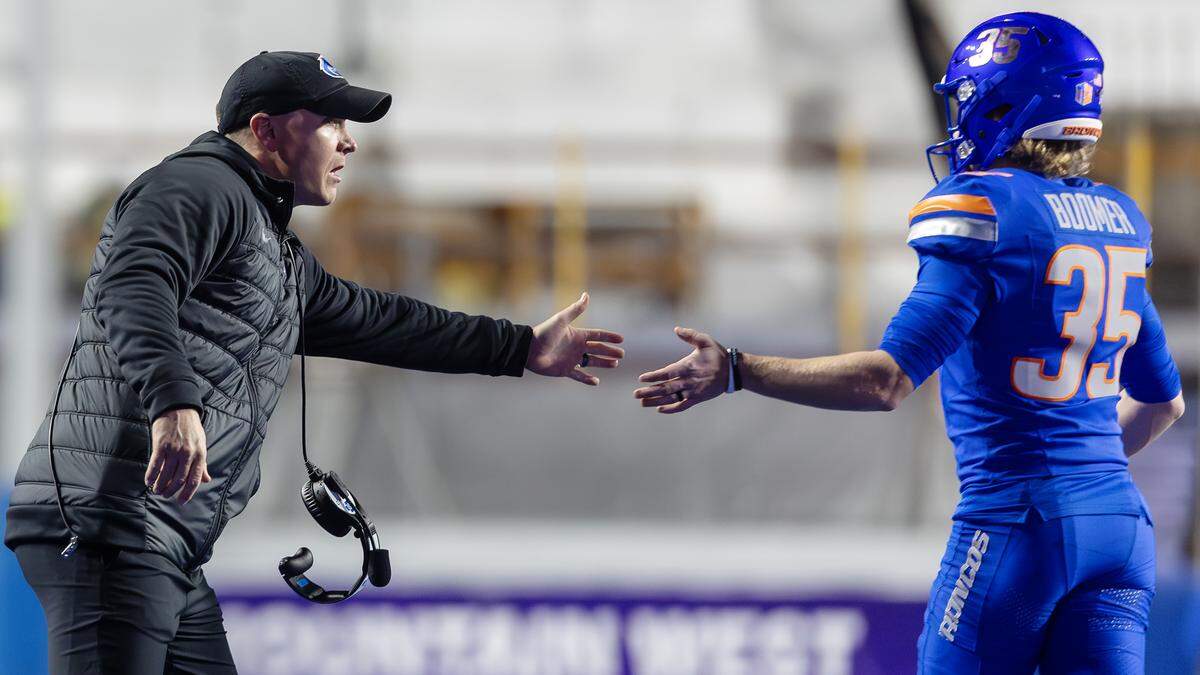 Boise State head coach Spencer Danielson greets kicker Colton Boomer after a score in the Mountain West Conference championship game. Boomer came to the Broncos as a transfer.