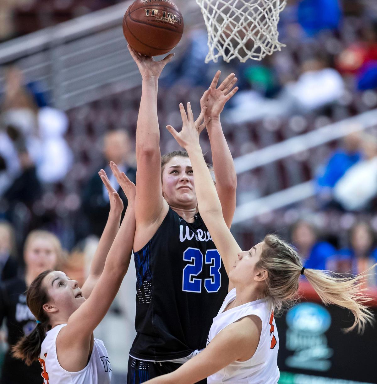 Timberline senior Emma Ellinghouse pulls up for a shot in the paint defended by Post Falls’ Maya Blake, right, and Capri Sims in the first round of the 5A state girls basketball tournament Thursday, Feb. 20, 2020 at Ford Idaho Center in Nampa.