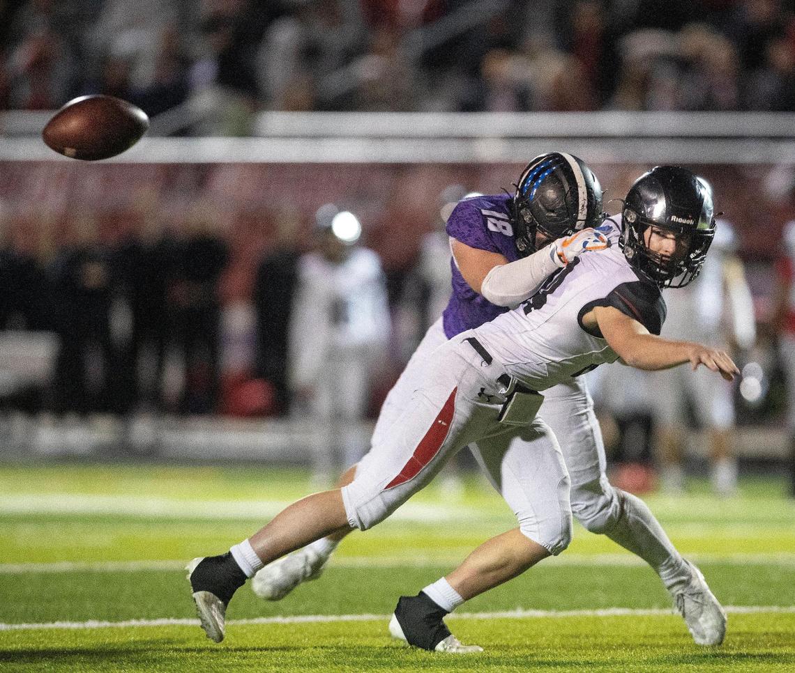Highland quarterback Jack Whitmer still completes a pass while being spun around by Rocky Mountain defensive lineman Parker Weatherly in the 5A state quarterfinals Nov. 5.
