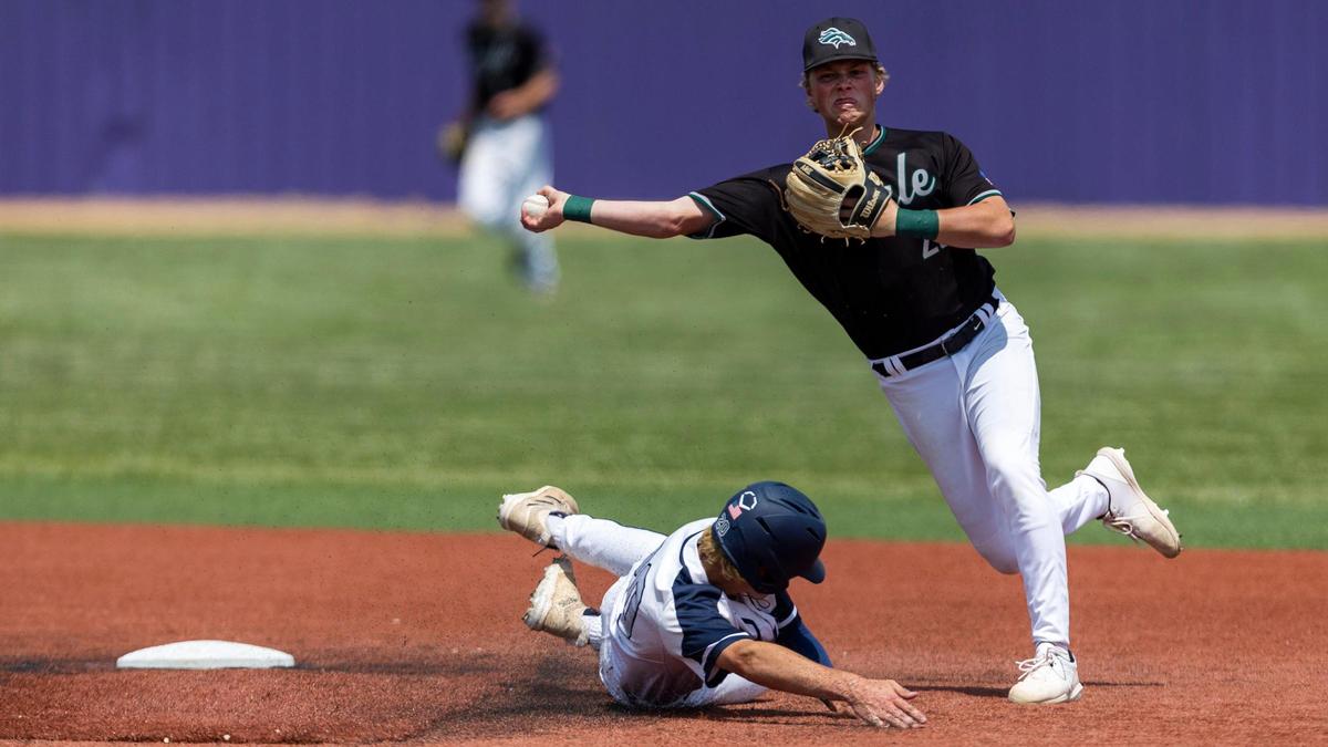 Eagle shortstop Bryson Shea turns a double play and avoids the slide from Lake City’s Cole Stoddard on Thursday during the first round of the 5A baseball state tournament at Wolfe Field in Caldwell.