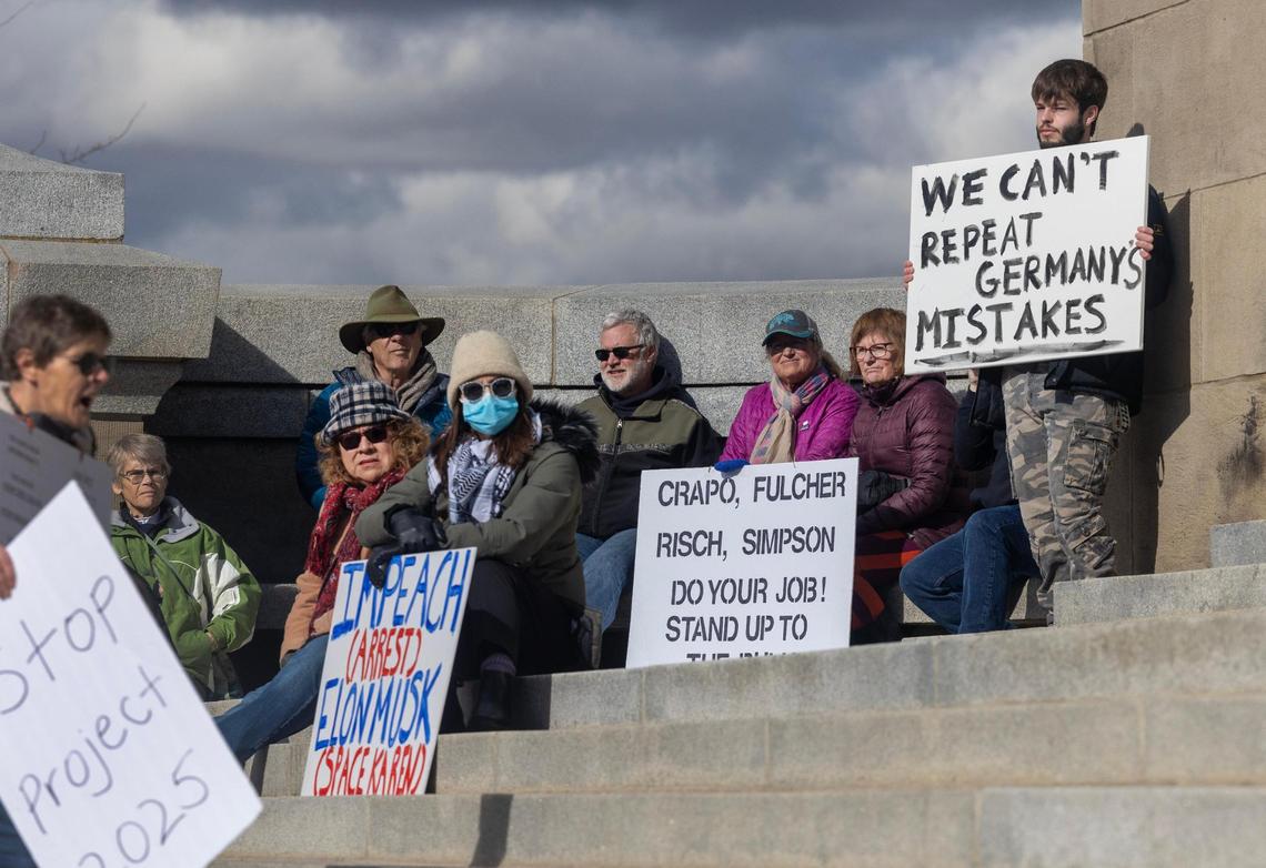 People hold a demonstration as part of the 50 protests, 50 states, one day movement Wednesday outside of the Idaho Capitol. The demonstration was held in protest of recent actions taken by President Donald Trump’s administration.
