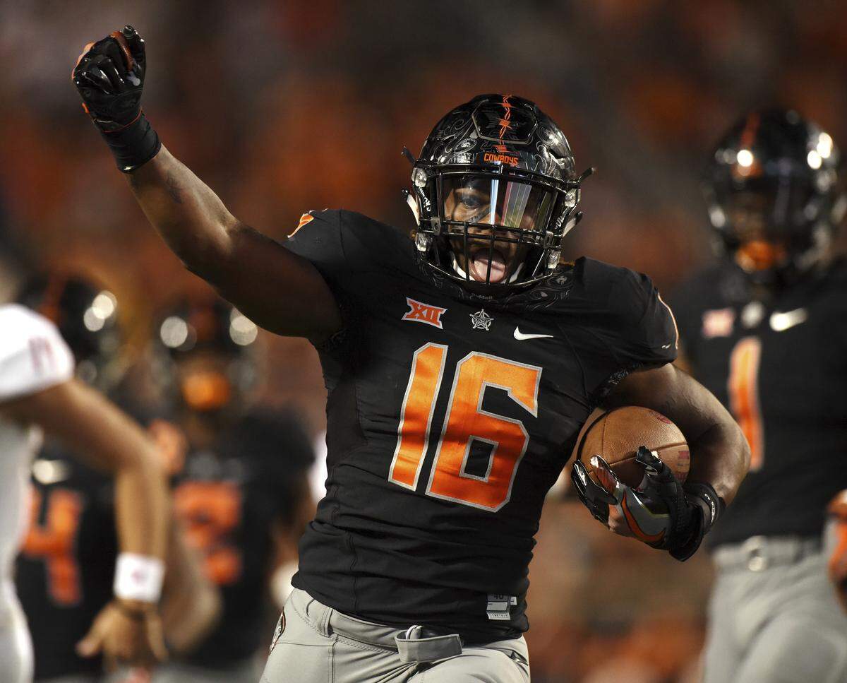 Oklahoma State linebacker Devin Harper celebrates an interception and subsequent touchdown during an NCAA college football game against South Alabama in Stillwater, Okla., Saturday, Sept. 8, 2018. (AP Photo/Brody Schmidt)